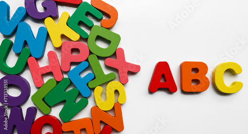 ABC wooden letters isolated on white background. ABC blocks connecting jigsaw puzzle. Symbol of business teamwork and baby kid intelligence development concept, cooperation, partnership.
