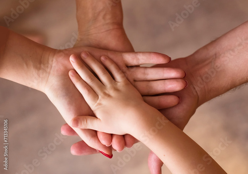Four hands together. Family. Children and parents
