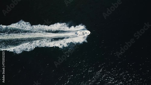 Top View of a motorboat cruising at high speed in the deep blue ocean  photo