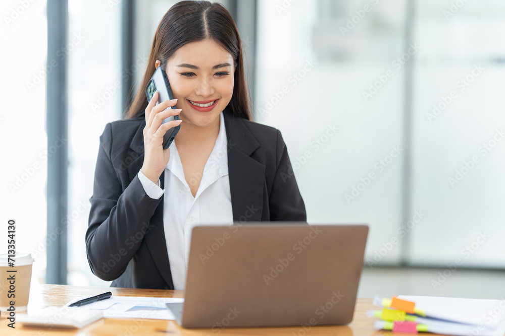 Young happy businesswoman working with tablet and document in corporate office. Young happy businesswoman working with tablet and document in corporate office.