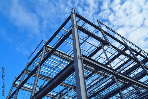 a steel building structure with blue sky behind it, piles/stacks, ornamental structures, precision of lines, sky blue, steel iron frame construction 