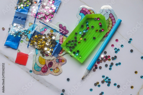 children's craft kit in the form of a diamond mosaic at the table