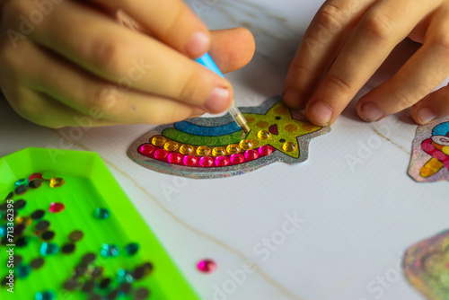 diamond mosaic set with crystals intermediate gluing process by child