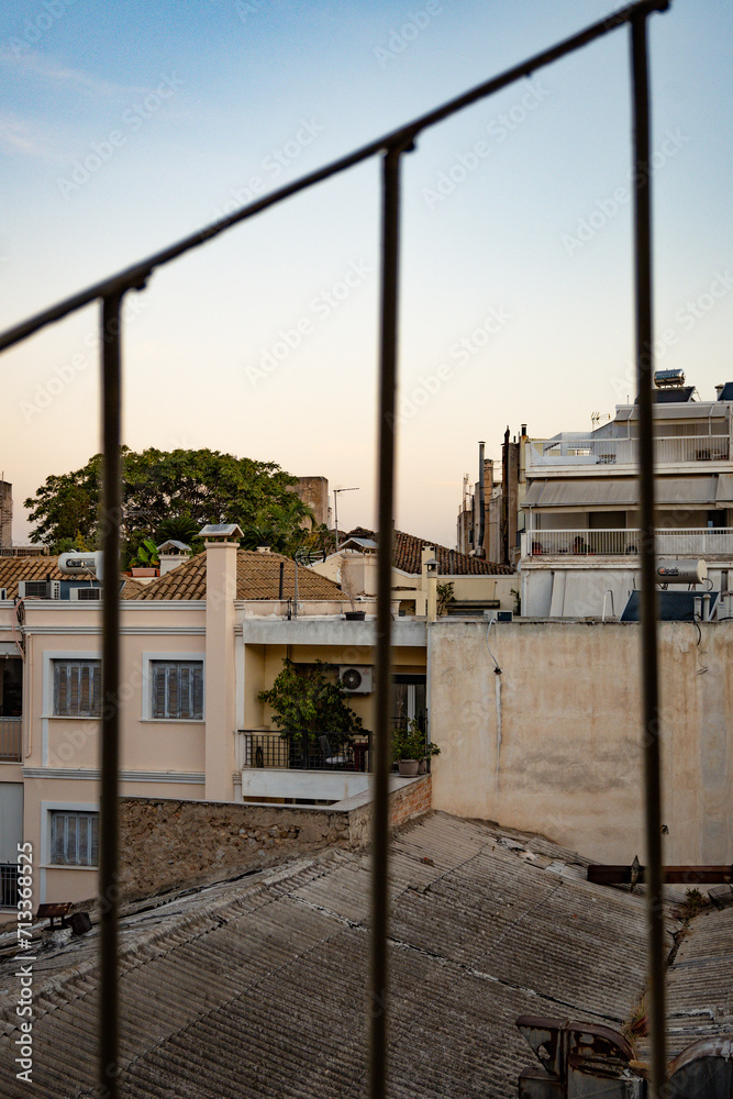 View of rooftops through a fire escape railing in Athens, Greece View of rooftops through a fire escape railing in Athens, Greece