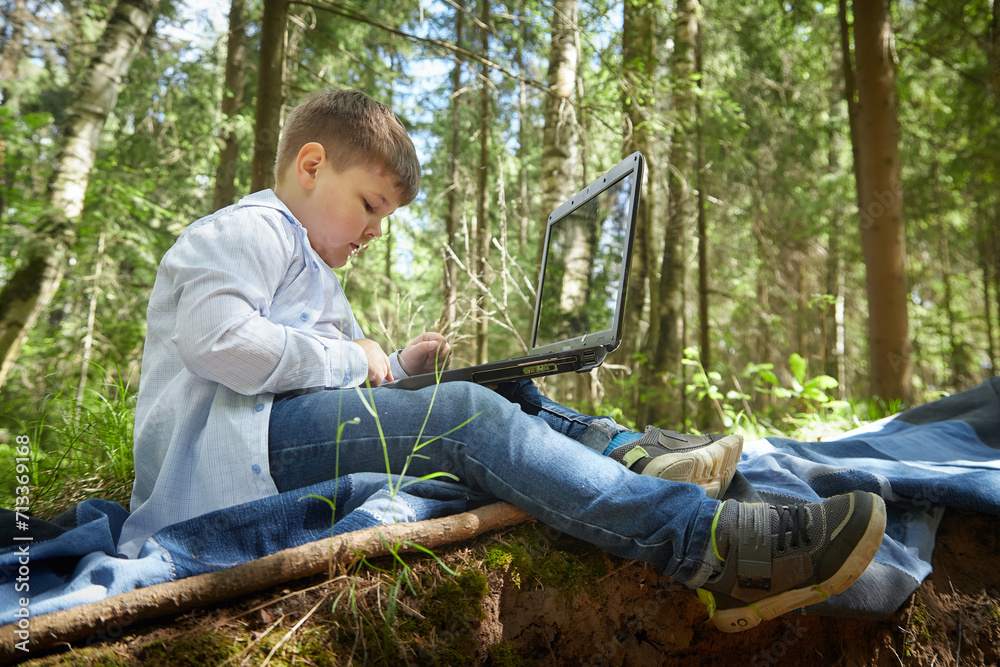 A fat teenage boy in the park with a laptop. Gamer, streamer, blogger, sociopathic programmer working alone in the forest A fat teenage boy in the park with a laptop. Gamer, streamer, blogger, sociopathic programmer working alone in the forest
