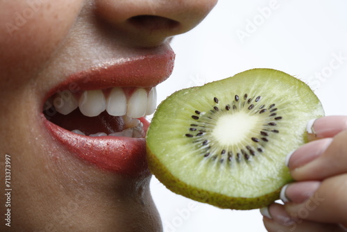 woman eating kiwi close up