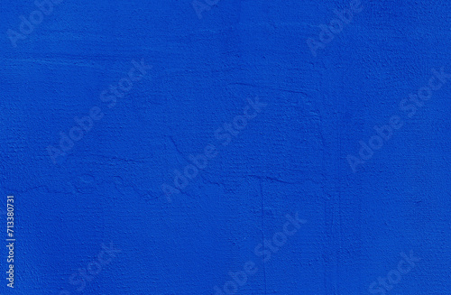 Blue wall background. Abstract wall surface with blue plaster texture for design. Close up.