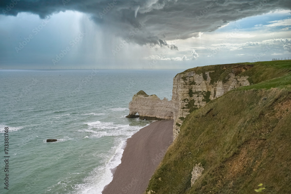 Etretat in Normandy, the famous cliffs and needle on the pebble beach ...