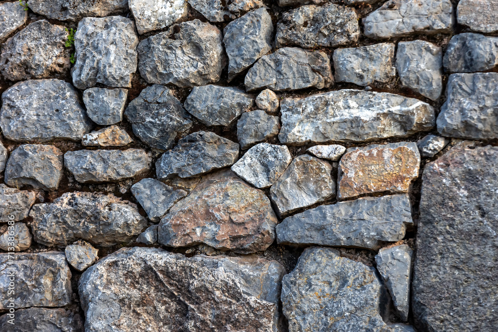 Background of stones. Masonry from stones of different sizes Background of stones. Masonry from stones of different sizes