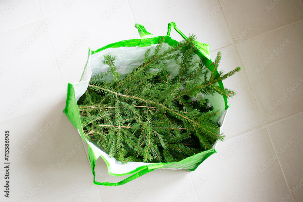 A pile of used Christmas trees in a bag ready for recycling. Christmas