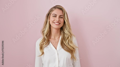 Zany young blonde woman wearing shirt stands over pink background, tongue out in a funny expression! pure fun and happy emotions flowing. photo
