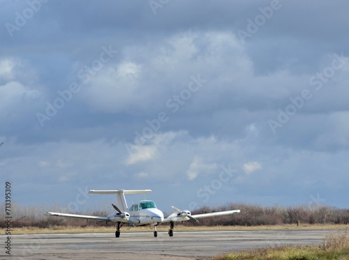 Summer, against the background of cloudsn airplane with two engines stands at the airport photo