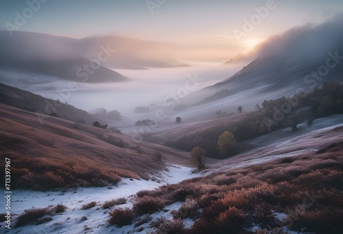 a sun shines through the mountains on a foggy hill