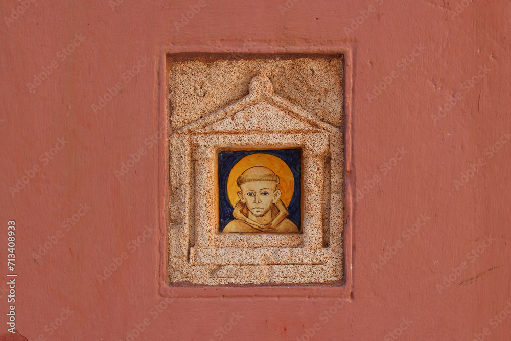 sculpted outdoor altar with the portrait of a monk in chania in crete in greece 