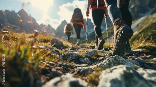 Close-Up of A group of hikers walking on a mountain path focus on Hiking Boots. photo