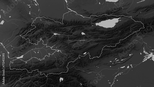 Kyrgyzstan outlined. Grayscale elevation map