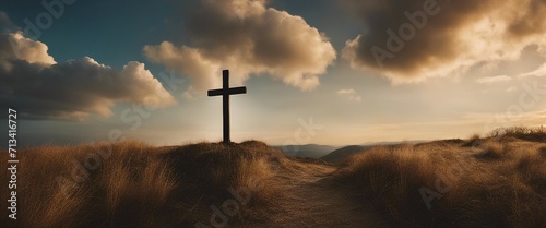 A wooden cross stands against a vivid sky, clouds parting around it, symbolizing hope and faith photo