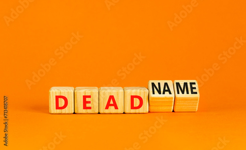 Deadname or name symbol. Concept words Deadname or Name on beautiful wooden blocks. Beautiful orange table orange background. Business, deadname or name concept. Copy space.