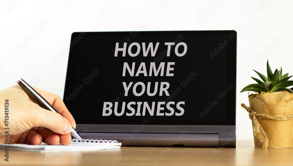How to name your business symbol. Concept words How to name your business on beautiful black tablet. Businessman hand. Beautiful white background. How to name your business concept. Copy space. How to name your business symbol. Concept words How to name your business on beautiful black tablet. Businessman hand. Beautiful white background. How to name your business concept. Copy space.