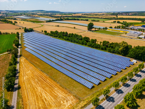 Solar field with solar panels on an agricultural field in sunshine