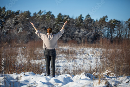 Woman meditating at sunset in the winter forest  © meegi