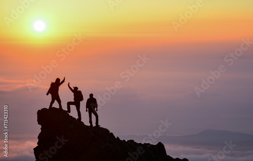 Young climbers congratulate each other at the summit