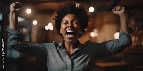 A carefree woman, adorned in elegant attire, expresses pure joy as she dances with her eyes closed and a beaming smile on her face indoors © Vladan