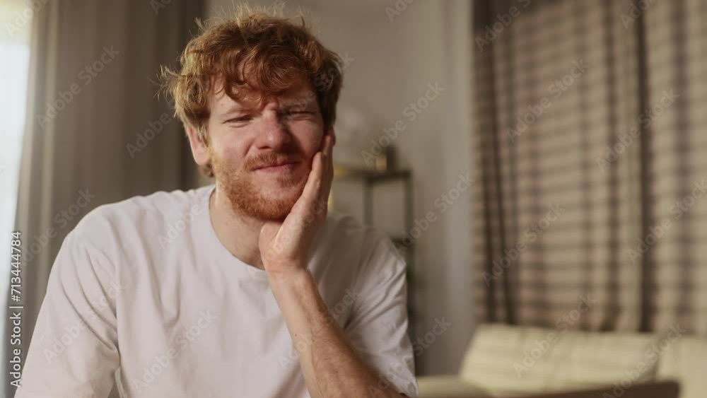 Young man freelancer working on laptop while having toothache at home workplace Sad male feeling pain in tooth because caries gum disease or sensitive teeth indoors Young man freelancer working on laptop while having toothache at home workplace Sad male feeling pain in tooth because caries gum disease or sensitive teeth indoors
