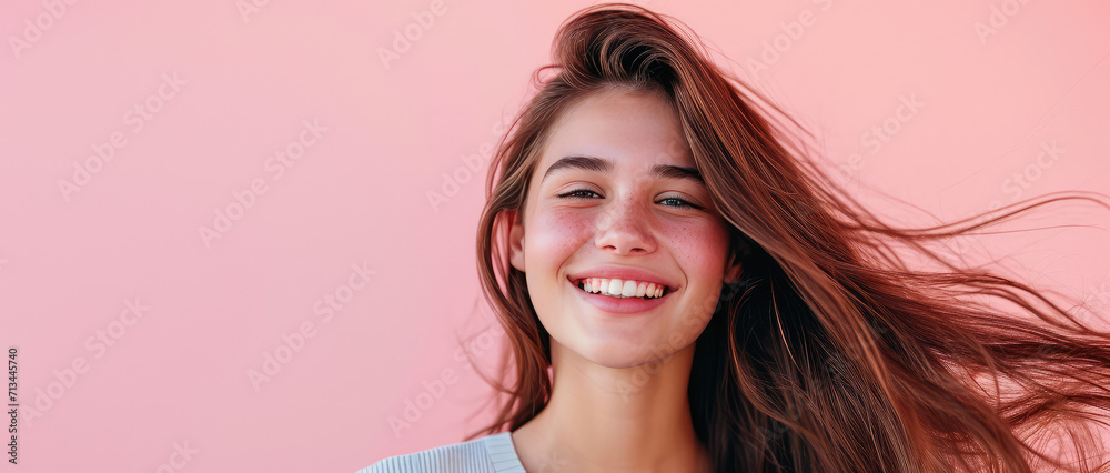 Fototapeta premium Smiling young pretty woman with brunette brown long groomed hair isolated on pastel flat pink background with copy space. Perfect hair care products banner template, hair salon.