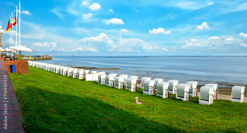 Beach with beach chairs and dike at the south beach in Wilhelmshaven, Germany