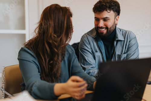 In the office, the male employee blurs lines by flirting with his colleague during work, creating an uncomfortable atmosphere in their professional collaboration.