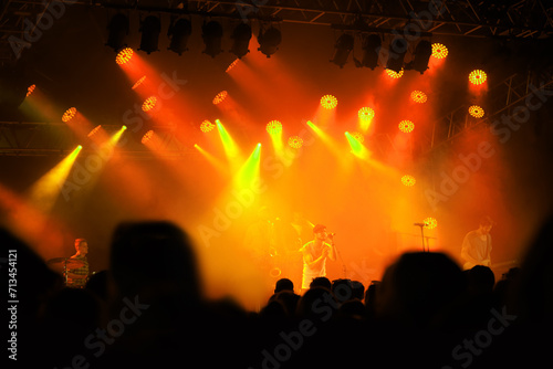Crowd silhouette, music band and concert audience listen to club artist, stage performance or celebrity star. Night event lights, rave festival and dark shadow group, fans or people at musician show