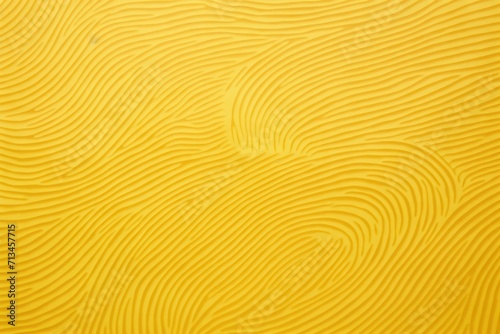  a close up view of a yellow surface with wavy lines and curves on the surface of the surface of the surface.