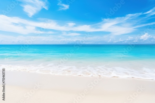  a sandy beach with clear blue water and a white sand beach under a blue sky with wispy clouds.