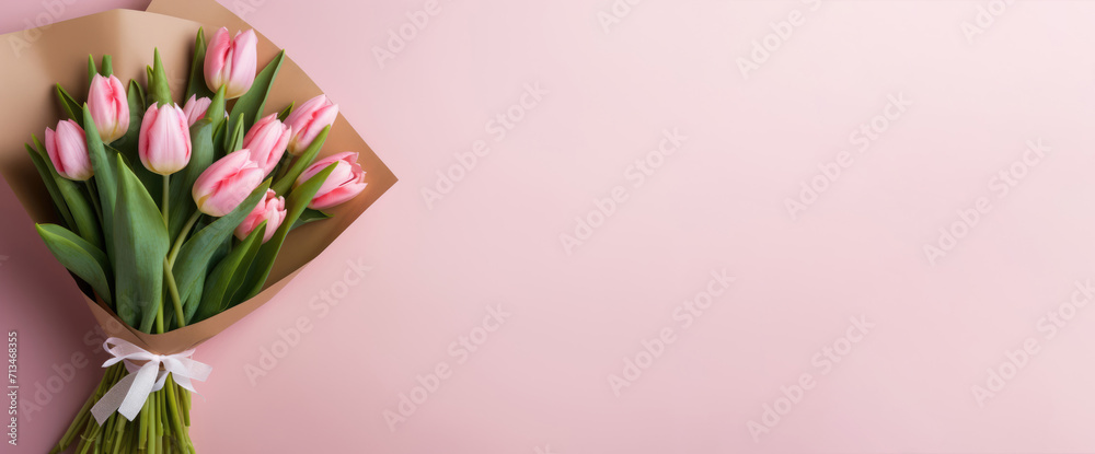 Bouquet of tulips on a pink background for Valentine's day, birthday or mother's day. Horizontal banner. Copy space for text