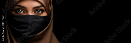Banner with portrait of a beautiful arabin woman in traditional hijab on the black background