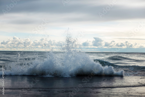 Fototapeta Naklejka Na Ścianę i Meble -  waves crashing on piers lake front in Chicago Lake Michigan with sky and clouds..