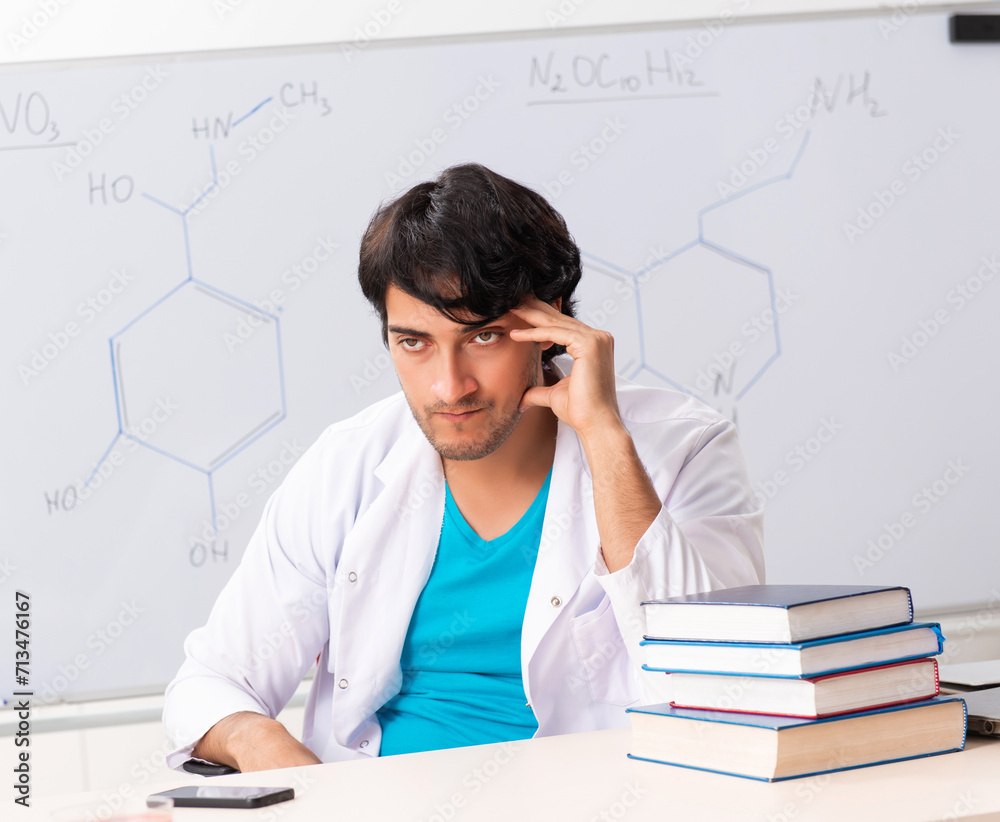 Fototapeta premium Young student chemist in the classroom