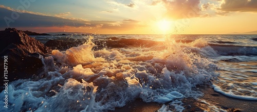 Beach sunset Beautiful panoramic landscape colorful golden sunset over calm sea with waves splashing softly on sandy beach Amazing sunset landscape summer nature peaceful nature. Copy space image