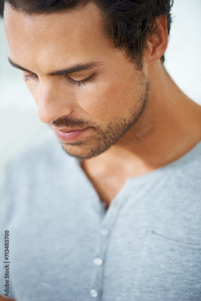 Face, thinking and regret with a young man closeup on a white background for error, mistake or fail. Depression, sad or worry and a concerned young person looking down with stress or anxiety Face, thinking and regret with a young man closeup on a white background for error, mistake or fail. Depression, sad or worry and a concerned young person looking down with stress or anxiety