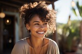 Portrait of a beautiful young woman with afro hairstyle smiling outdoors
