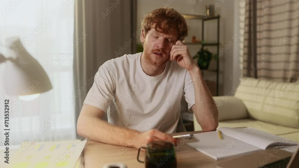 Attractive young red haired man at home workplace get notification and feeling upset reading bad negative news message at smartphone indoors Disappointment Fail Unemployment Attractive young red haired man at home workplace get notification and feeling upset reading bad negative news message at smartphone indoors Disappointment Fail Unemployment