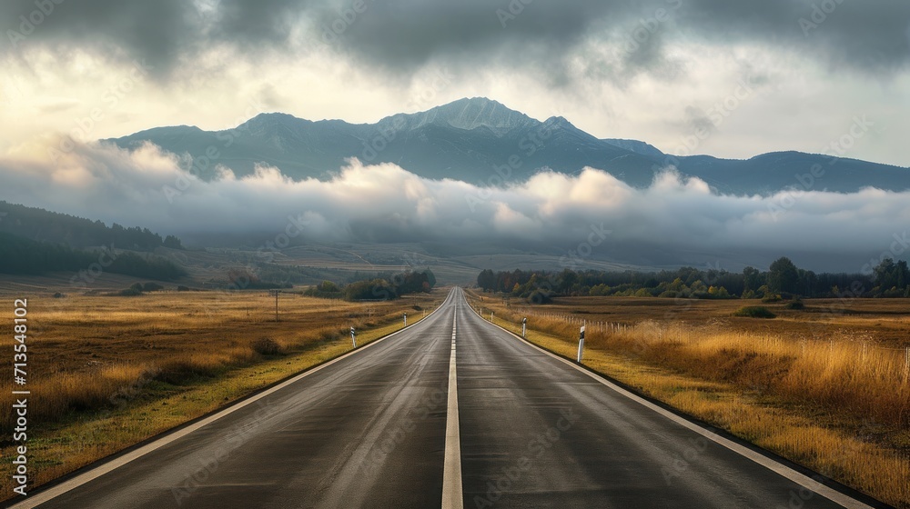 Serene Road Cutting Through Majestic Mountains