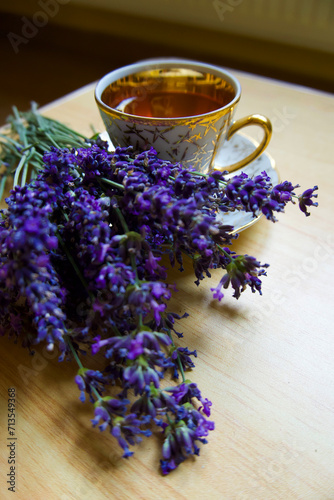 Fresh delicious tea with lavender and lavender flowers on wooden table