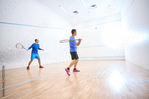 Motivated young men are learning squash techniques