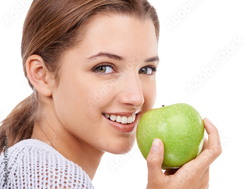 Woman, portrait and eating apple, nutrition and gut health with snack or meal, diet for weight loss on white background. Healthy food, wellness and fruit, vegan and organic with smile in studio