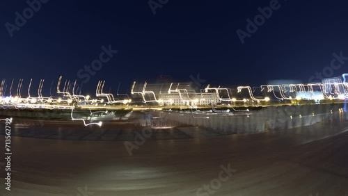 Muscat the capital of Oman, night time lapse taken with action camera, light trails timelapse,time warp vieo of busy traffic close to the main mosque photo