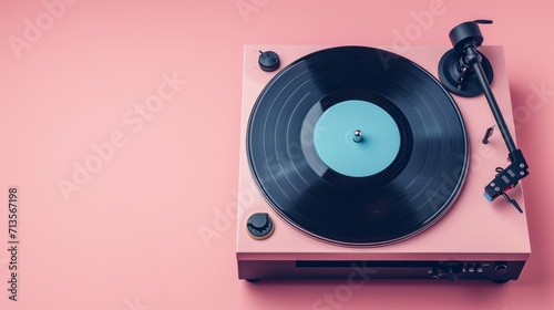 Record player with vinyl disk on pink background