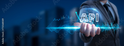 API: Businessman Holding API Icon and Global Network with Analyzing Technological Data, Seamless Integration, Network Connection on Interface Background, Advanced Connectivity, Data Exchange. photo