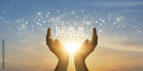 M&A. Man Holding Global Network and Connecting Data of Mergers & Acquisitions with Business on the Internet, Strategic Partnerships, Corporate Synergy. photo